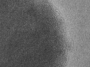 Scanning electron micrograph of a particle of the new battery material. Dark area indicates the inside of the particle surrounded by a lighter surface layer only five nanometers wide. Image courtesy / Ceder Lab