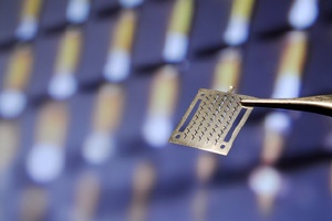 Image shows an array of microneedles against a microscope image. Photo: Gary Meek