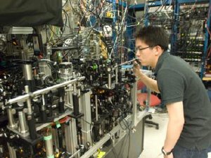 Graduate student Gyu-boong Jo optimizes the laser beam position on the mirror of the optical setup that produced an ultracold gas of lithium ions.  Photo - Patrick Gillooly 