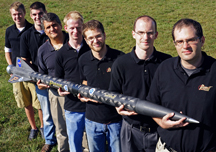 Purdue is working with NASA, the Air Force Office of Scientific Research and Pennsylvania State University to develop a new type of rocket propellant made of a frozen mixture of water and "nanoscale aluminum" powder. The propellant, called ALICE, is more environmentally friendly and could be manufactured on the moon, Mars and other water-bearing bodies. Holding a rocket launched earlier this year using the propellant, from left, are: mechanical engineering undergraduate student Cody Dezelan, mechanical engineering graduate student Tyler Wood, mechanical engineering professor Steven Son, aeronautics and astronautics graduate student Mark Pfeil, mechanical engineering doctoral student Travis Sippel, aeronautics and astronautics research assistant professor Timothée Pourpoint, and postdoctoral researcher John Tsohas. (Purdue University photo/Andrew Hancock)