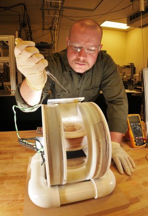 Kyle Solis, a graduate student intern in Nanomaterials Sciences, prepares a sample for mixing using a new approach called vortex field mixing. (Photo by Randy Montoya)