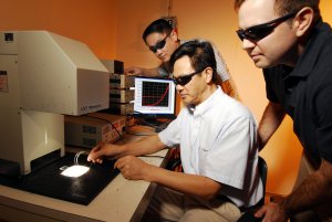 Georgia Tech researchers Yaguang Wei, Zhong Lin Wang and Benjamin Weintraub (left-right) examine a prototype of their three-dimensional solar cell based on optical fiber. Georgia Tech Photo: Gary Meek