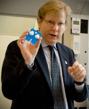 John McDevitt holds the prototype lab-on-a-chip card. Credit: Jeff Fitlow/Rice University