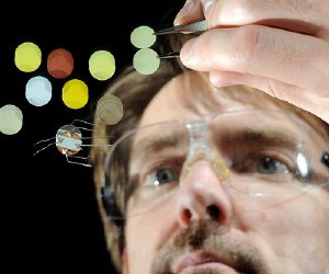 Argonne chemist Jeff Elam examines solar cell materials prepared using atomic layer deposition at various stages of fabrication. 