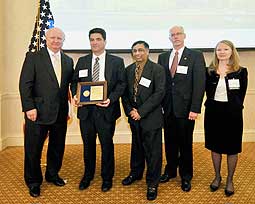 DOE Secretary Samuel Bodman (far left) conveys the Award of Achievement for the timely and efficient construction of the CINT complex to (from left to right) William Ortiz, NNSA Sandia Site Office federal project director; Altaf (Tof) Carim, DOE