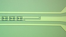 In the JILA/NIST “noiseless” amplifier, a long line of superconducting magnetic sensors (beginning on the right in this colorized micrograph) made of sandwiches of two layers of superconducting niobium with aluminum oxide in between, creates a