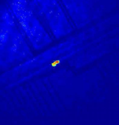 A dilute cloud of a few thousand ultra-cold atoms a few micron-meters above the surface of an AtomChip. The electrodes of the chip are visible in the background.