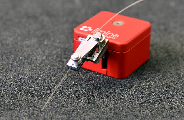 A miBot manipulator can be used to position precisely an optical fiber over a sample for localized light collection and delivery.