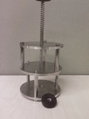 Powder sample press with sample holder.