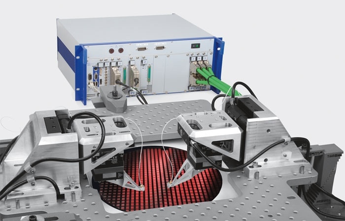 Silicon Photonics (SiP), the convergence of photonics and semiconductors promises a leap in data throughput, parallelism and energy efficiency. Wafer level testing and packaging economics both demand extraordinary speed and parallelism. This is achieved by a combination of motorized and piezoelectric drive technologies along with high-speed, firmware-based search and align algorithms. (Image PI)