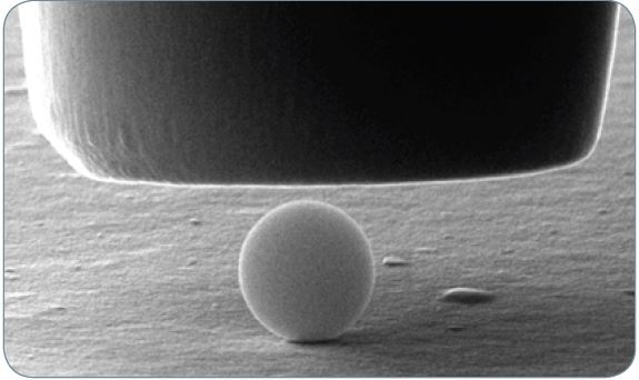 A 1 µm silica particle prior to compression with a 5 µm flat punch probe.