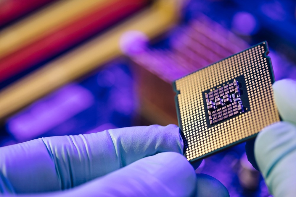Computer support engineer installing processor. Microprocessor with clearly visible silicon core and cache chip. Installation of computer processor in the socket.