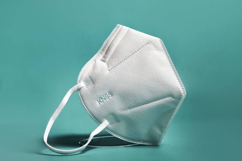 White FFP2, KN95 respirator. Dust protection respirator or medical respiratory mask against the virus. Surgical protective mask. prevention of the spread of coronavirus pandemic COVID-19 SARS-COV-2