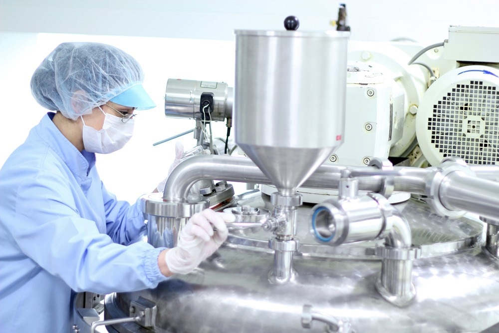 Preparing machine for work in pharmaceutical factory. Chemical industry. Pharmaceutical Factory Worker. Pharmaceutical Industry.