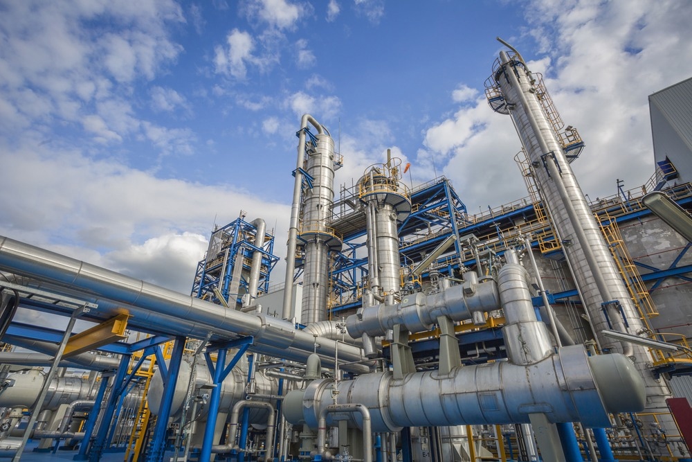 Refinery tower in petrochemical industrial plant with cloudy sky