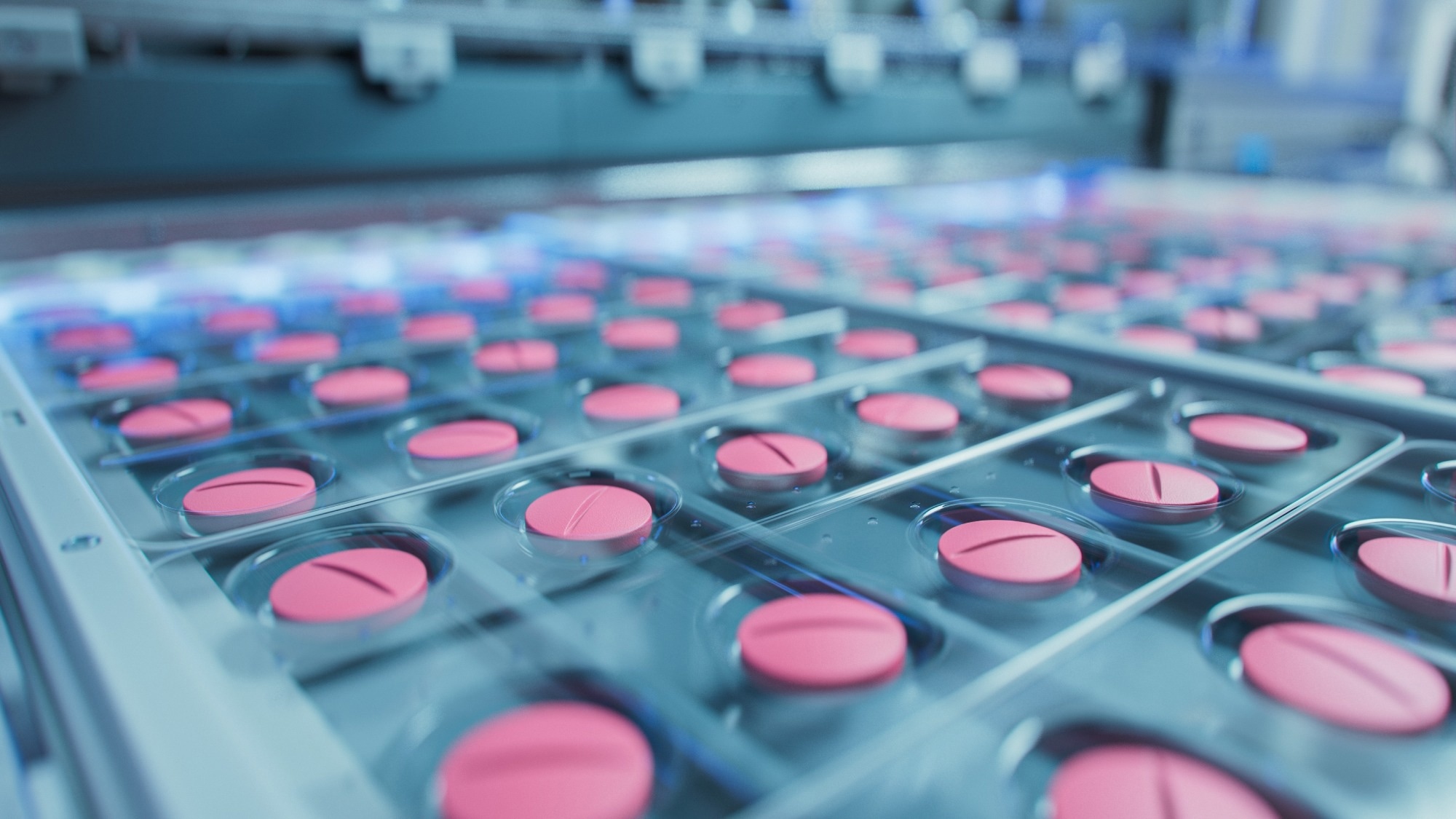 Macro Shot of Pink Pills During Production and Packing Process on Modern Pharmaceutical Factory.