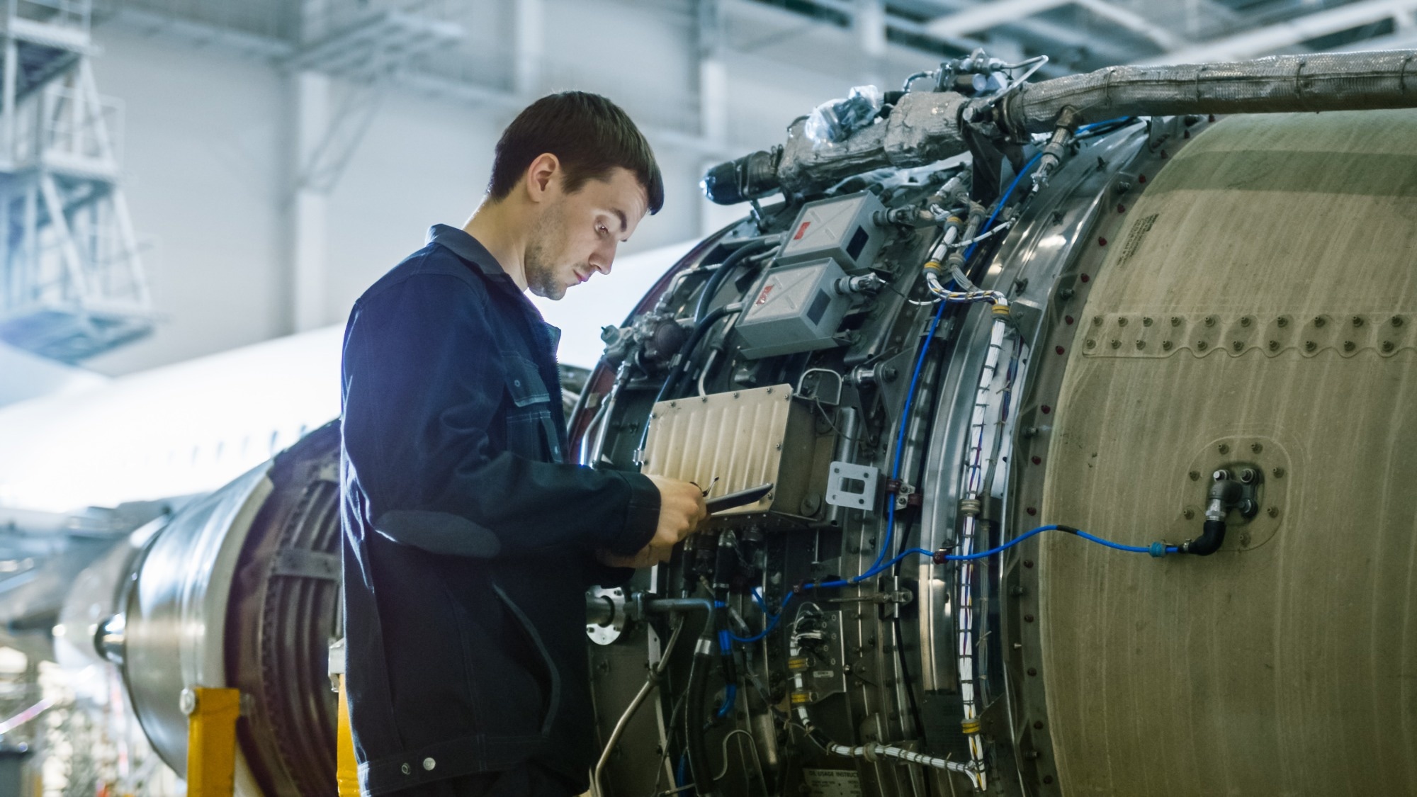 Aircraft technician monitoring levels of a plane.