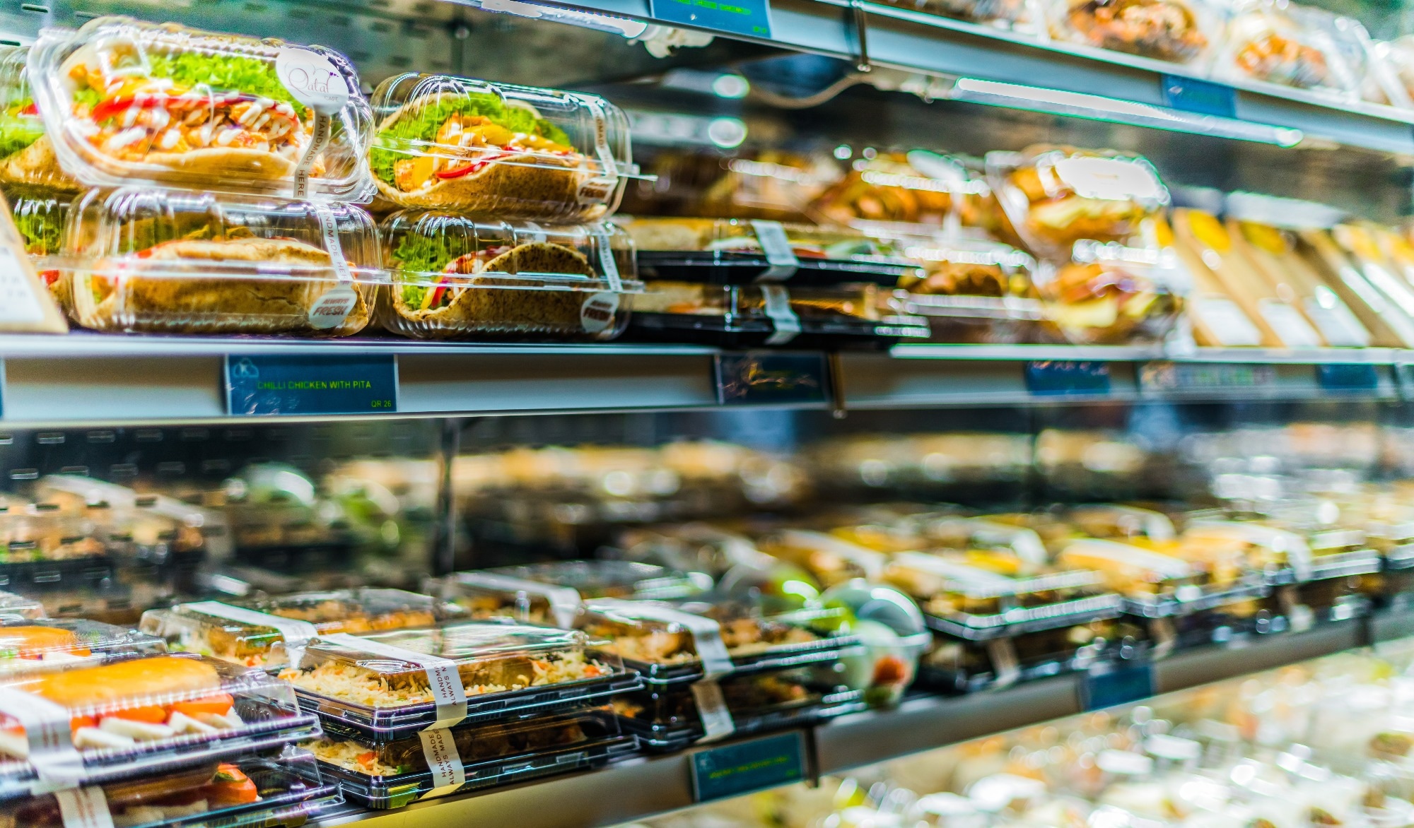 Supermarket sushi on a shelf.