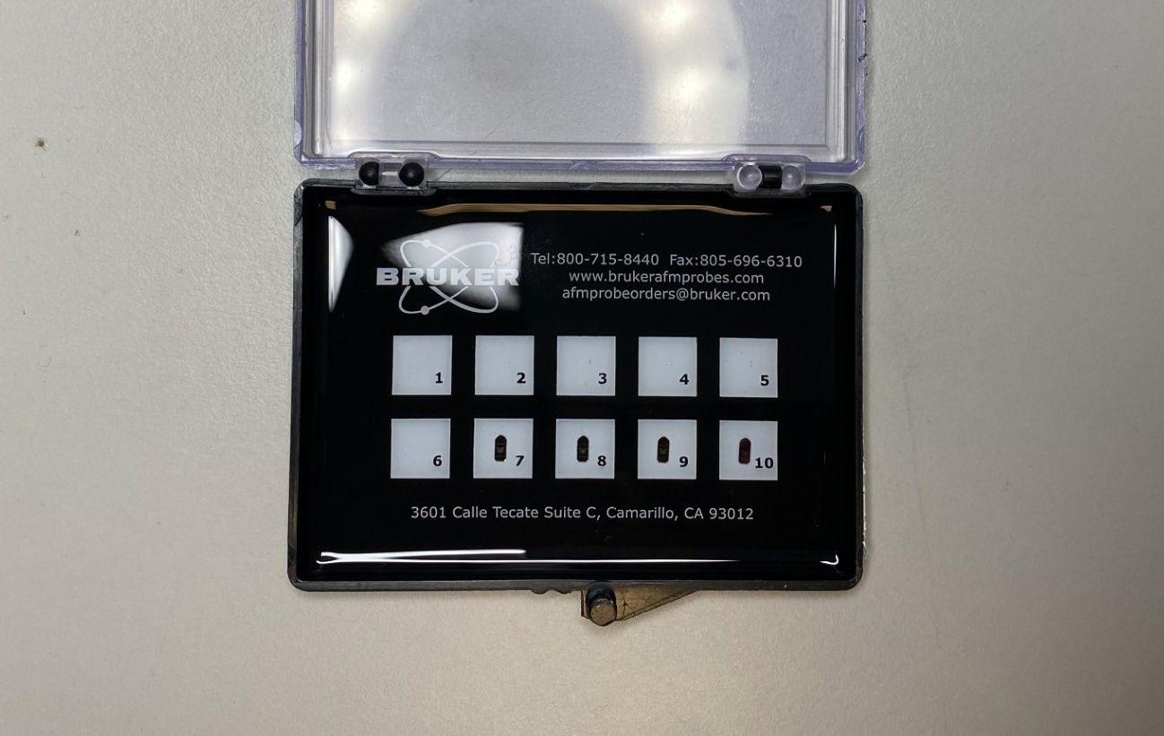 Bruker AFM needles in their case. Barely visible in the light, all that can be seen in this image is their holder.