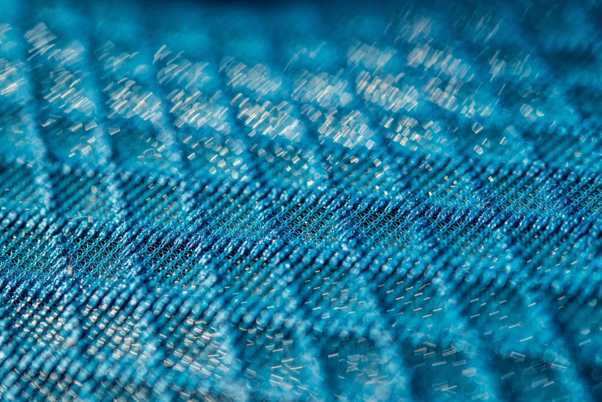 Blue 3d texturised technological seamless breathing fabric closeup.