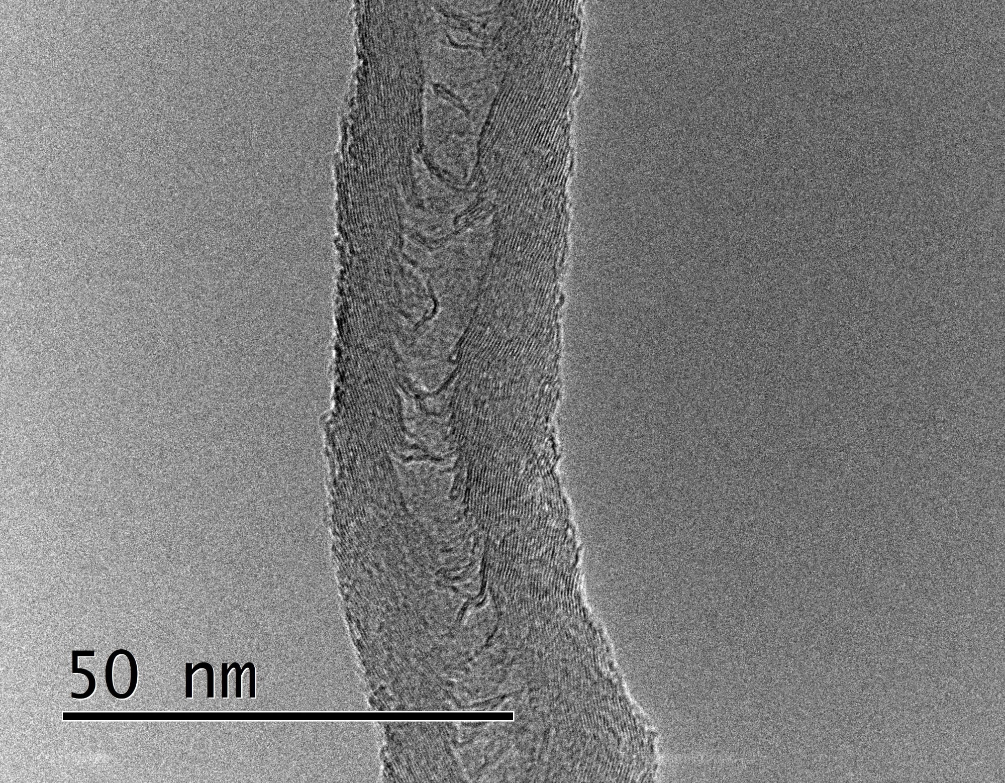 A single multiwall carbon nanotube crosses the center of a black and white scientific imaging picture, with a 50 nm scale showing the width is ~ 25 nm.