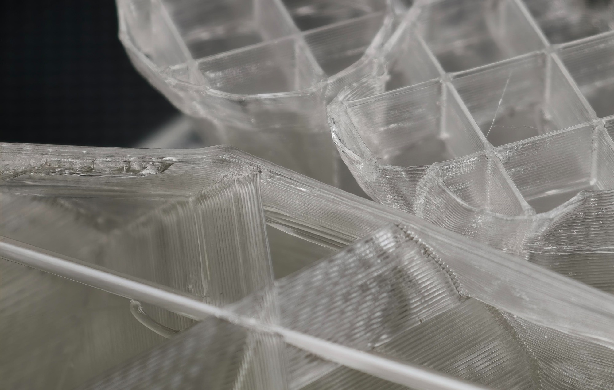 Close-up of a 3D printed object with visible layer lines and translucent material