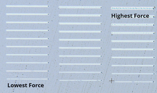 Scribe force test on silicon to determine optimum scribe force; the lowest force is at the bottom left, increasing to the maximum at the top right