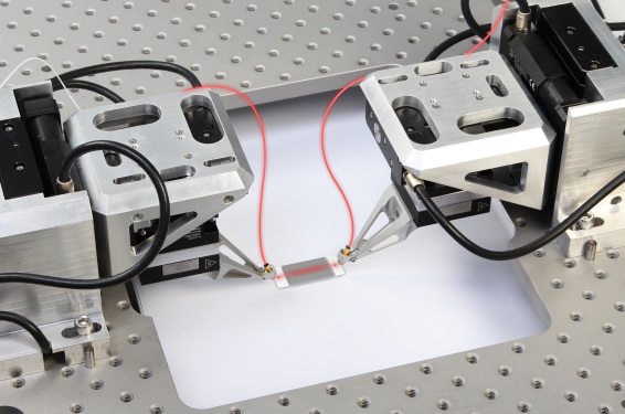 Aligning the inputs and outputs of waveguide devices at an industrial pace requires parallel optimization and nanoscale accuracy.