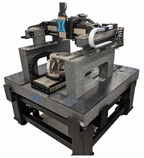 A custom granite-based A-351 gantry system with and additional long-travel linear axis and 6- DOF hexapod
