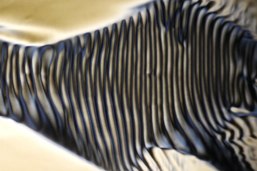 Stripes in a Flowing Liquid Crystal Suggest a Route to “Chiral” Fluids