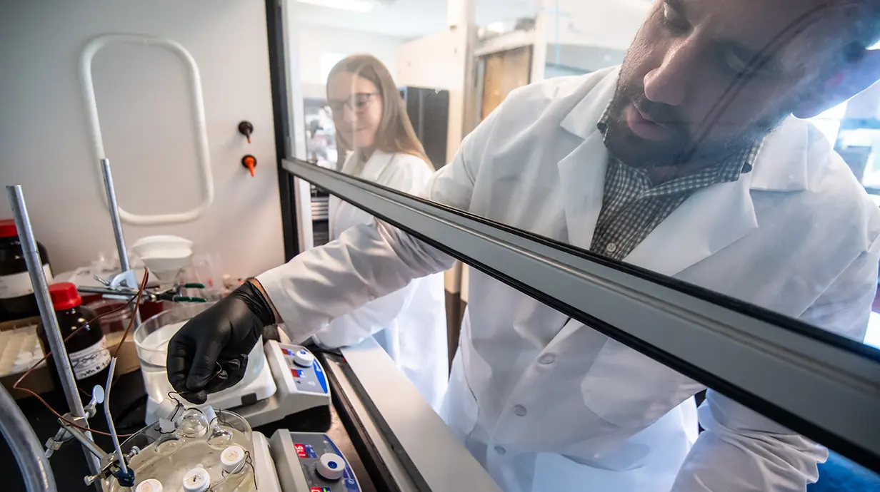 Thomas Werfel (right), associate professor of biomedical engineering, has published an article that suggests cancer drug delivery can be improved by coating nanoparticles that contain the medication in a sugar-like substance called glycopolymer.