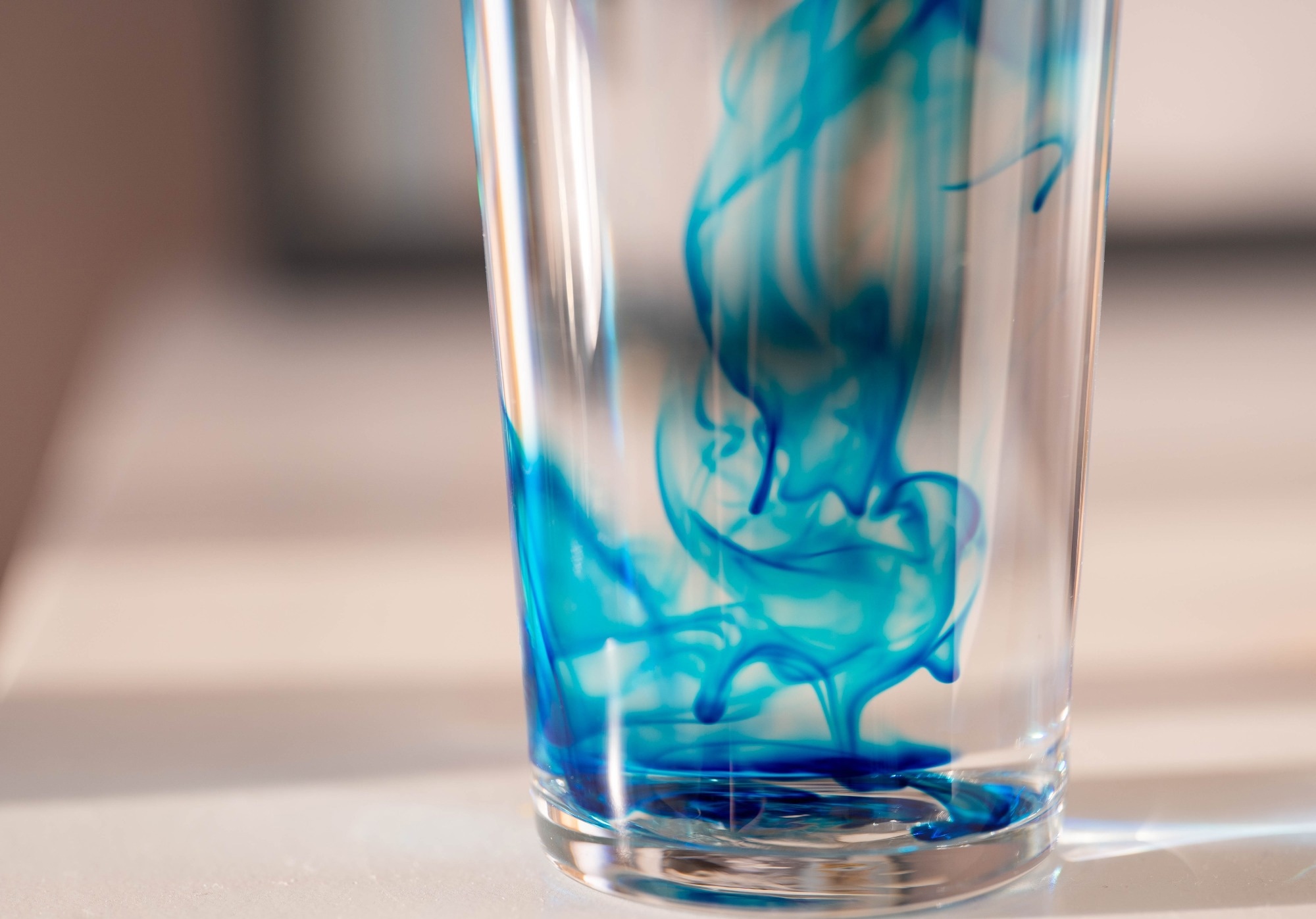 abstract closeup image of methylene blue in a glass of water