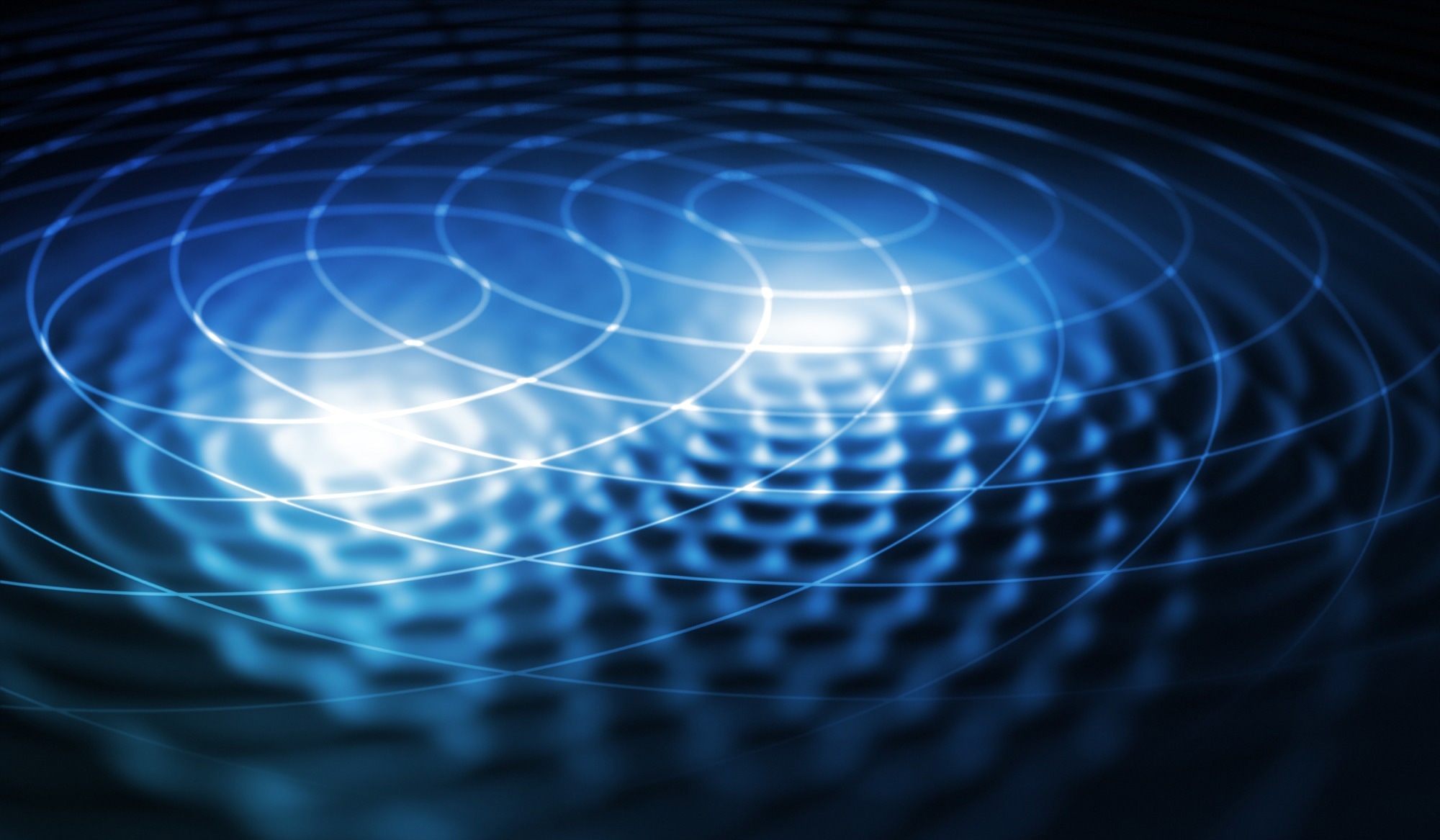 Abstract representation of electromagnetic waves with concentric ripples and glowing blue light