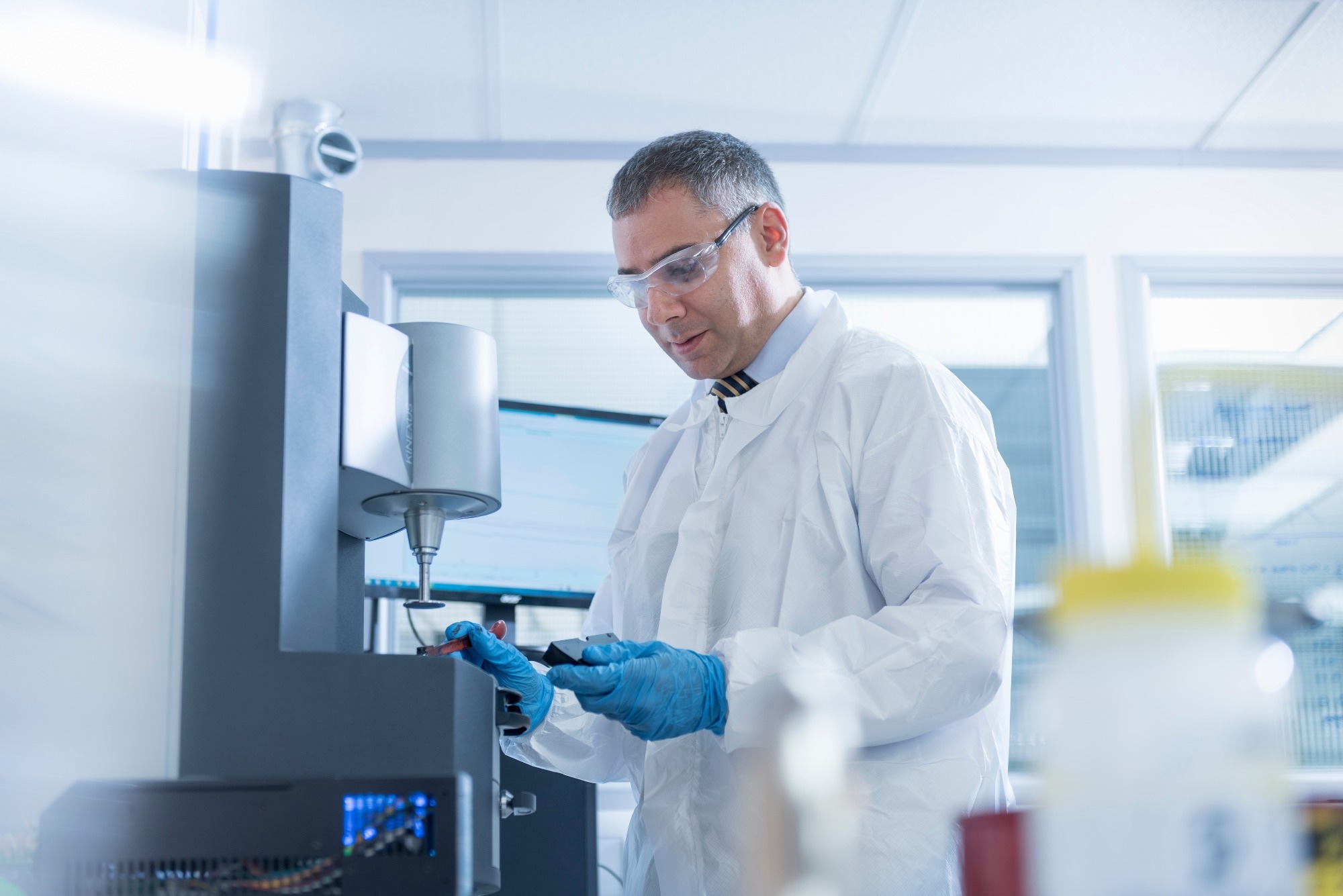 Scientist uses rheology machine to test graphene ink in graphene processing factory