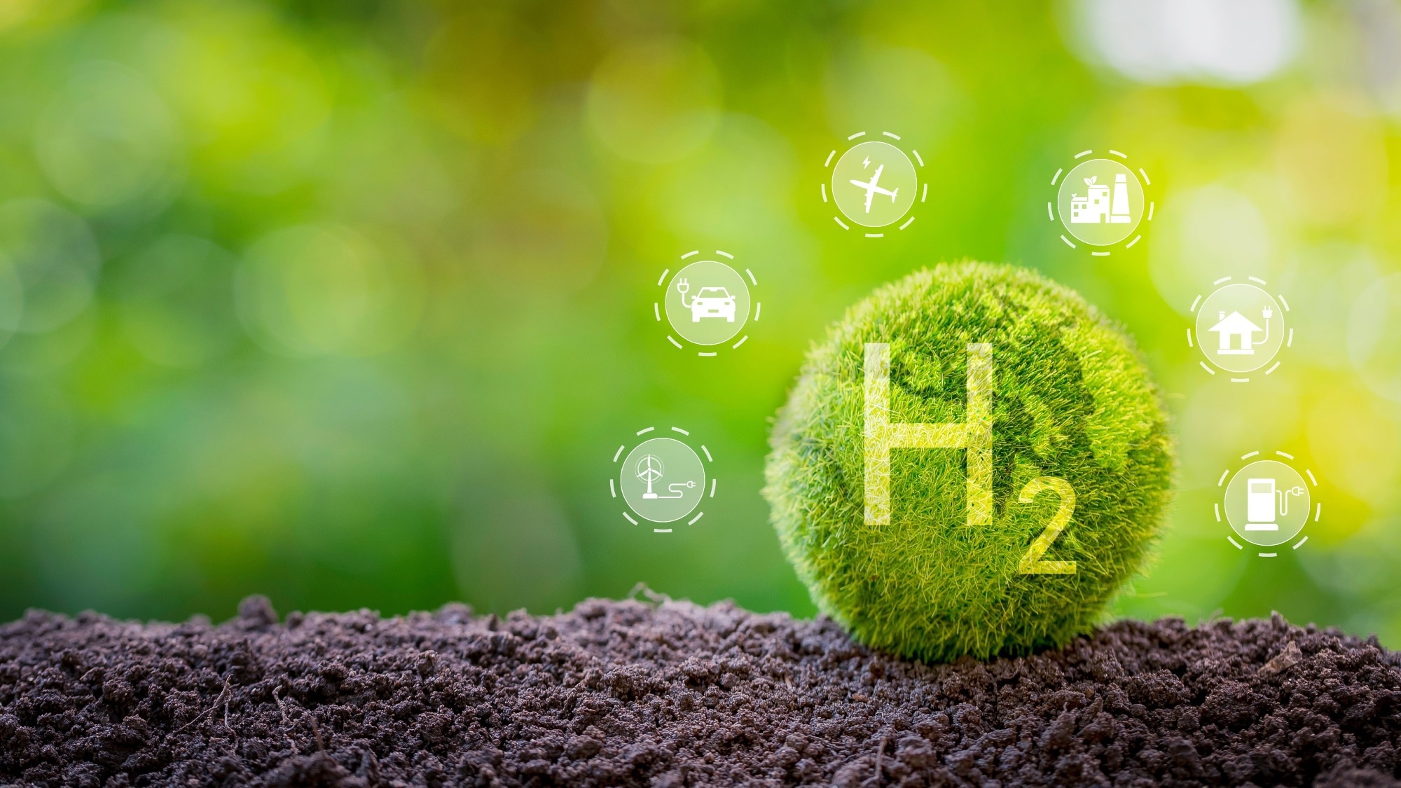 Green hydrogen symbol (H2) on a moss-covered sphere resting on soil, surrounded by clean energy and sustainability icons, representing eco-friendly hydrogen production and renewable energy applications.