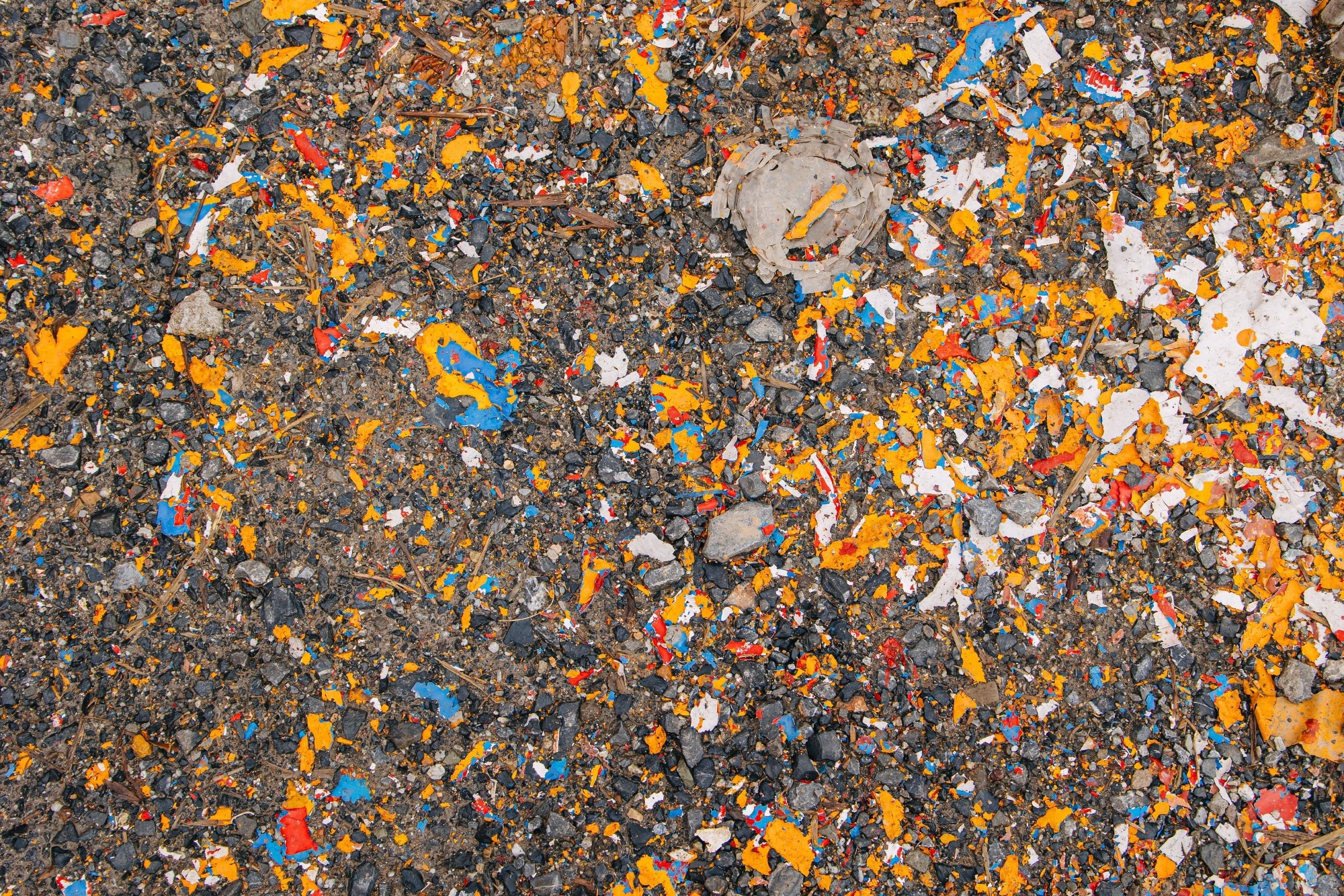 A landfill site with degrading colourful plastics.