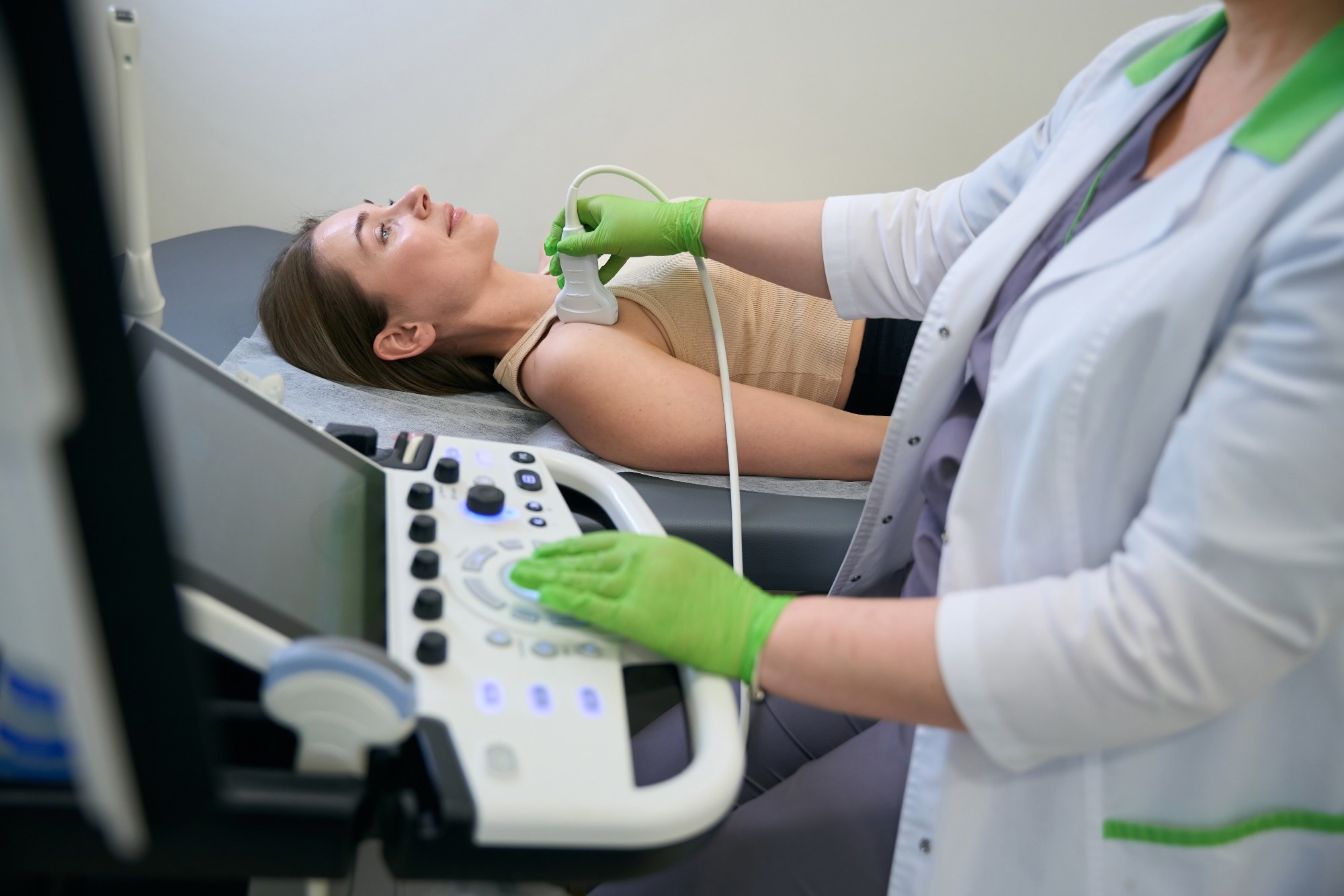 A doctor uses ultrasound technology to examine a women