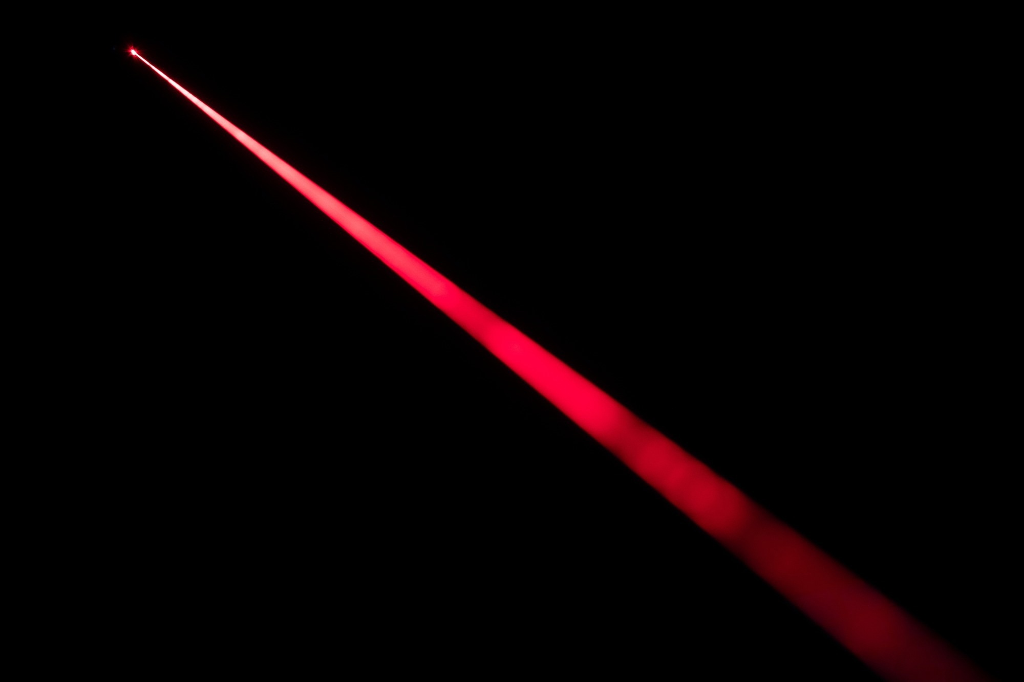Close up of laser beam isolated on black background.