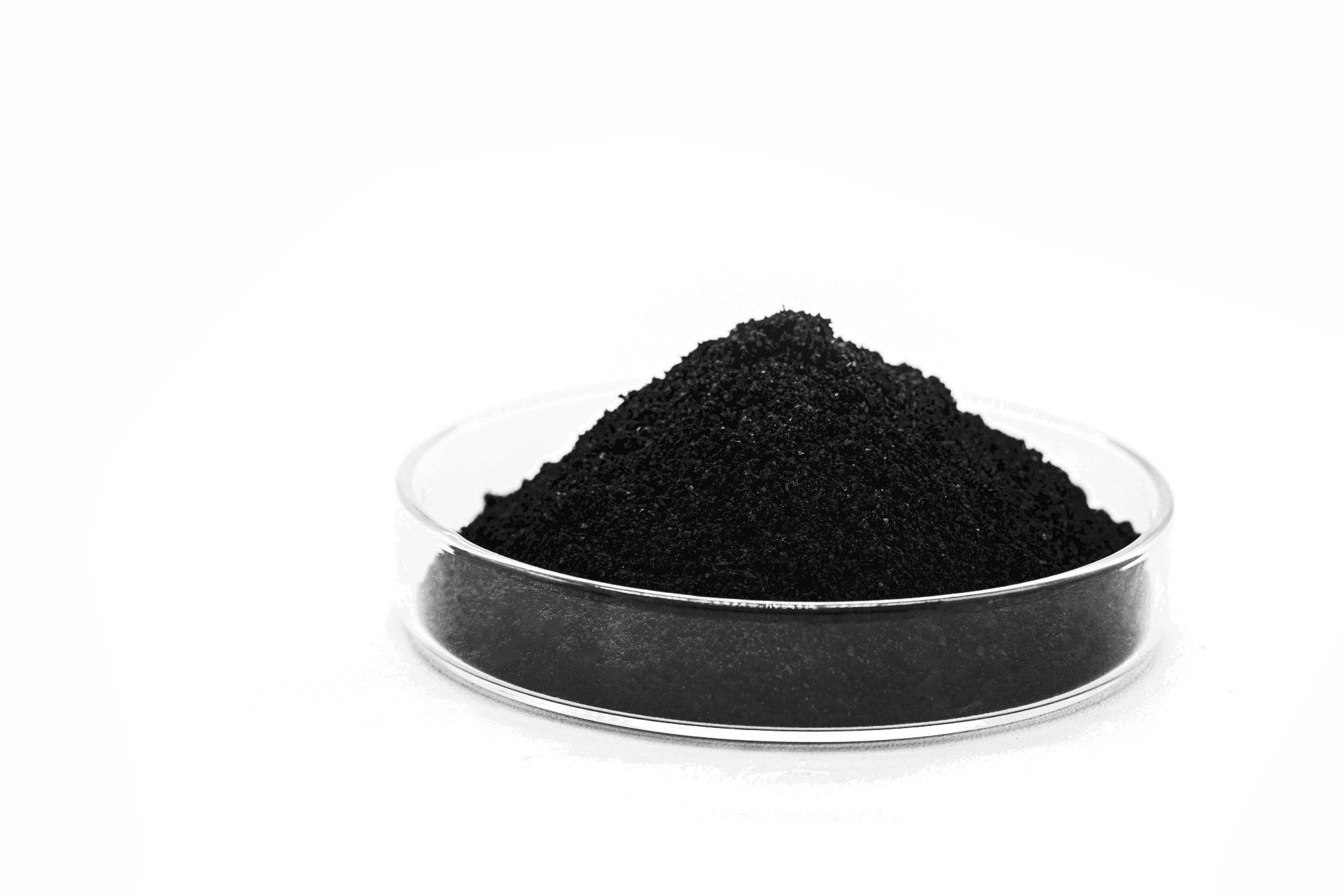graphene oxide powder in a petri dish against a stark white background.