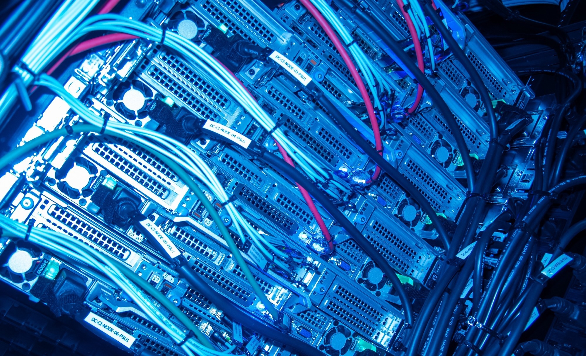 A close-up view of a high-tech server rack showcasing colorful cables and cooling systems.