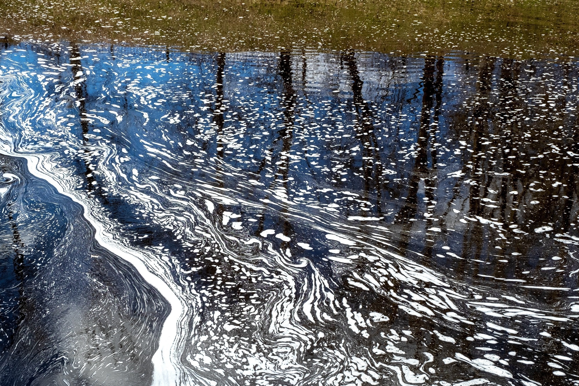 Foam on polluted water depicting chemical and other pollution.
